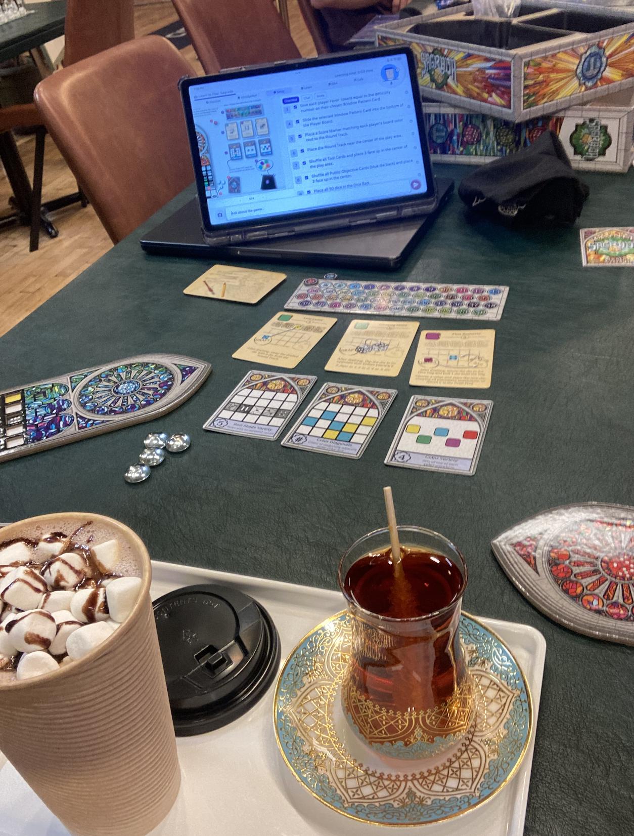 A tabletop game session at a local café with drinks